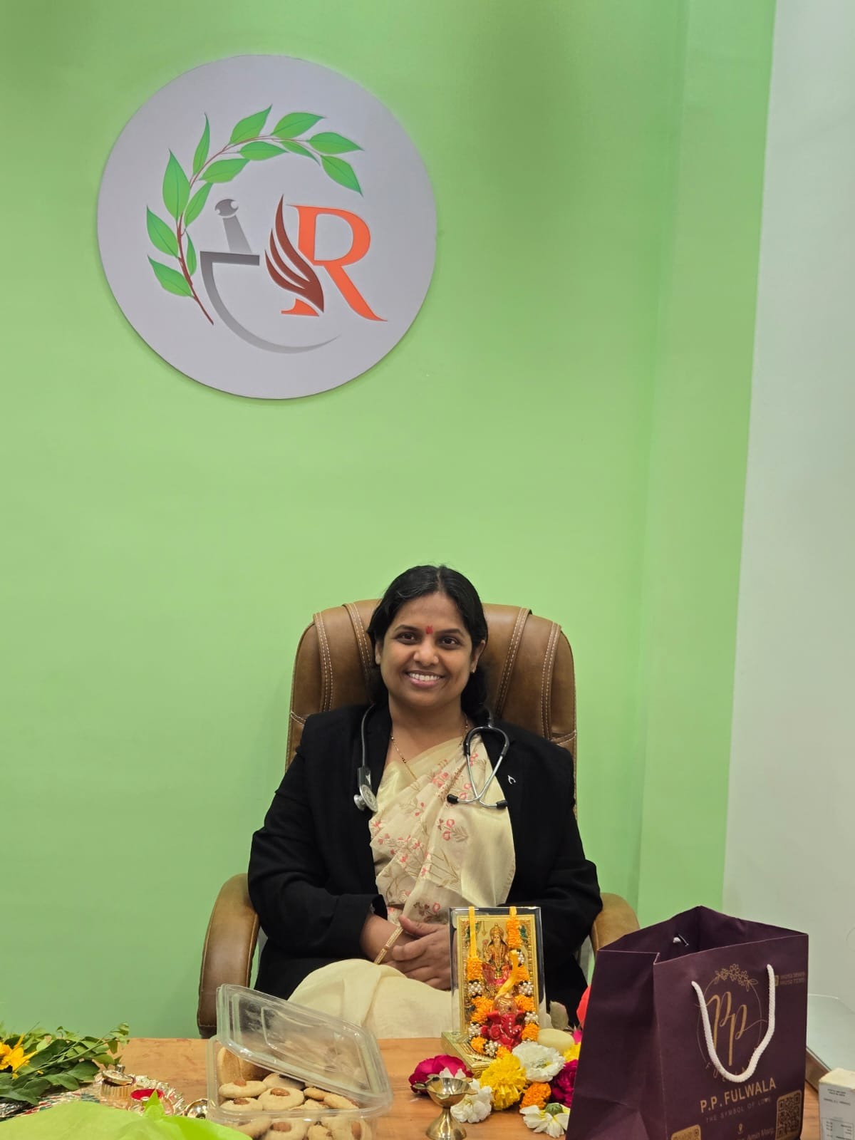Dr. Minakshee Vijay Telang seated in her clinic