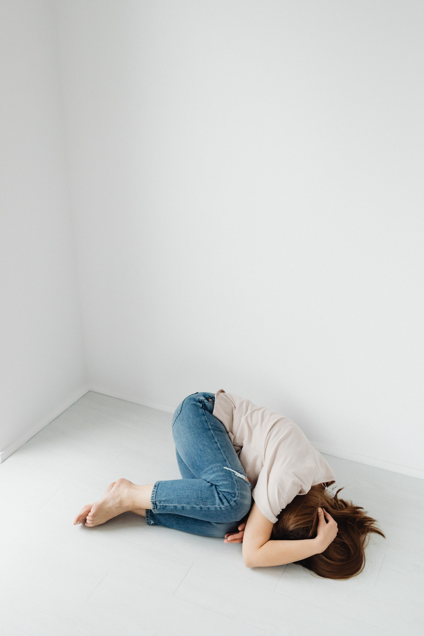 A person resting in a quiet, minimal room