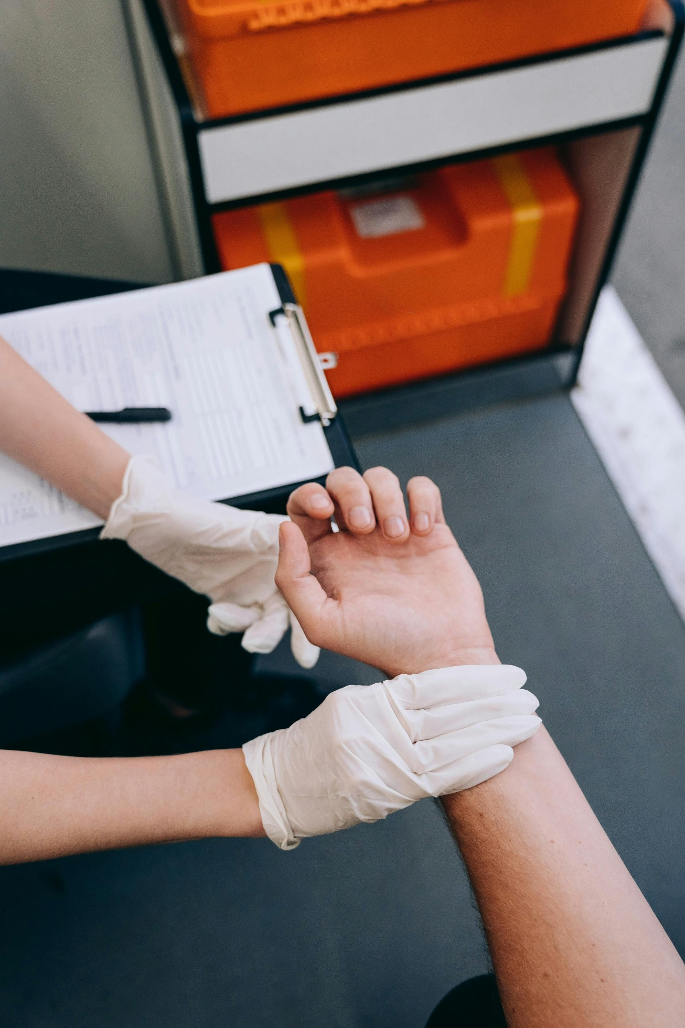 A practitioner checking a patient's pulse